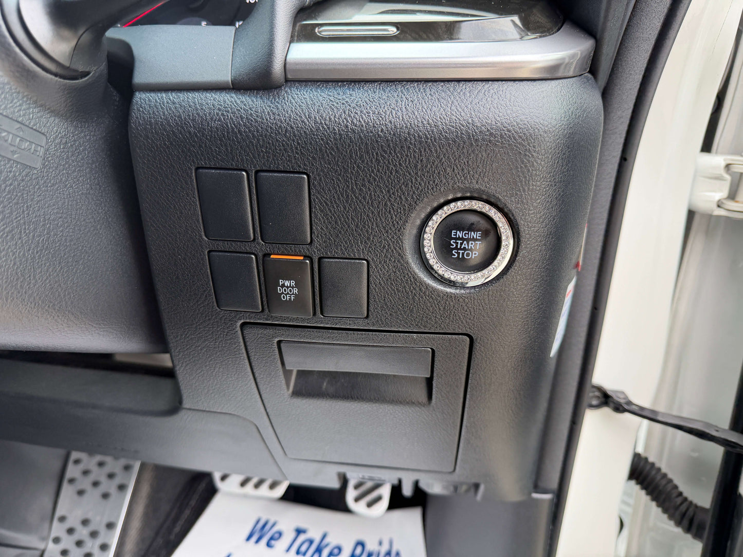 Control panel interior view showing engine start-stop button and switches in 2016 Toyota Alphard 2.5L.