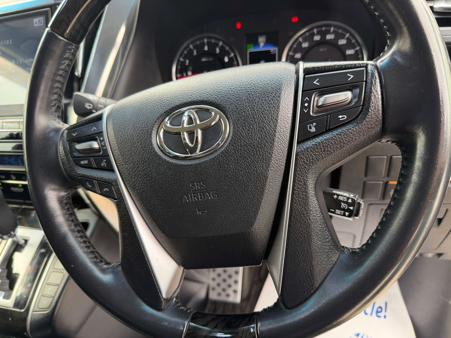 2016 Toyota Alphard 2.5L steering wheel with controls, showcasing luxury design and features.