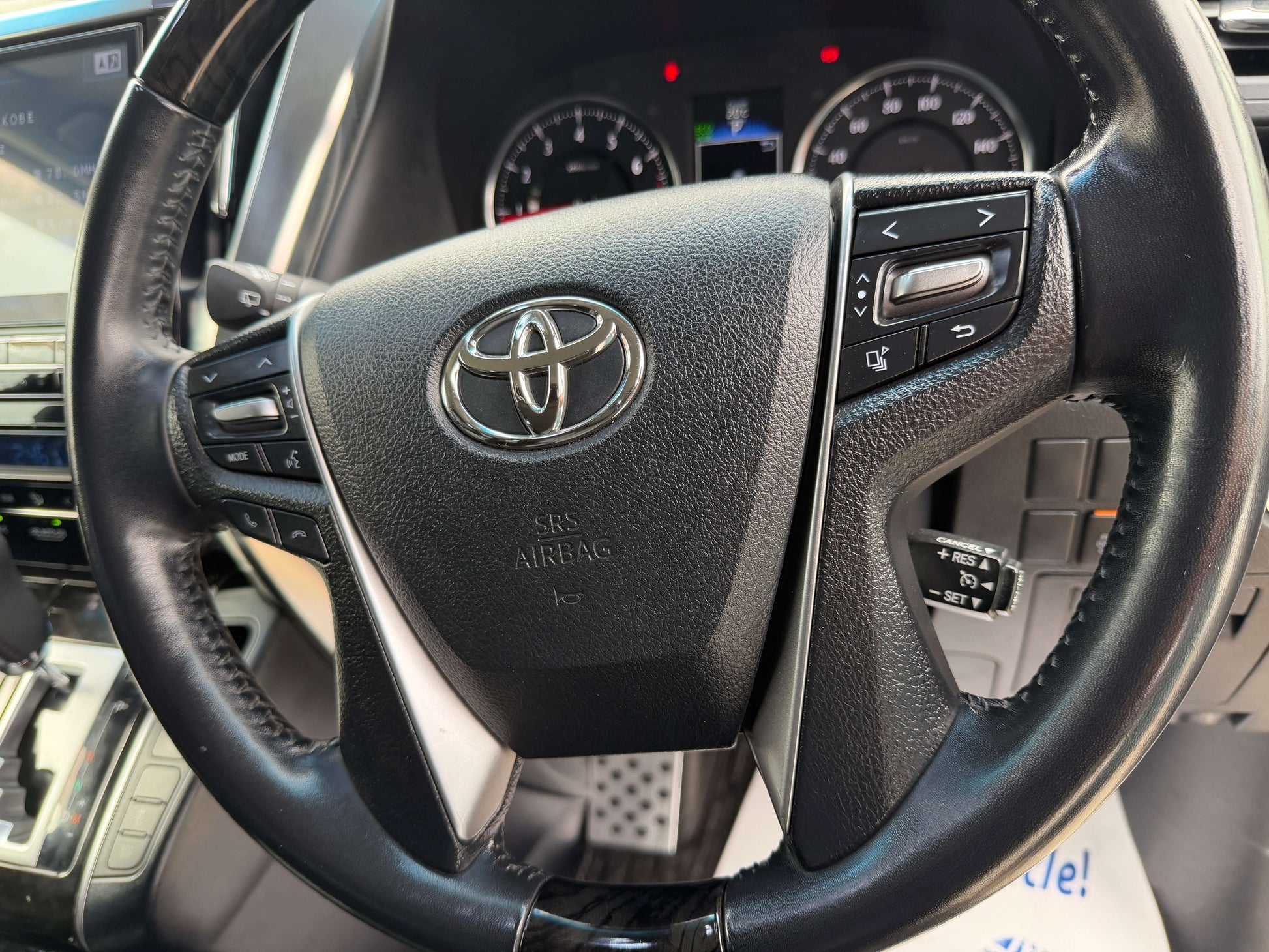 2016 Toyota Alphard 2.5L steering wheel with controls, showcasing luxury design and features.