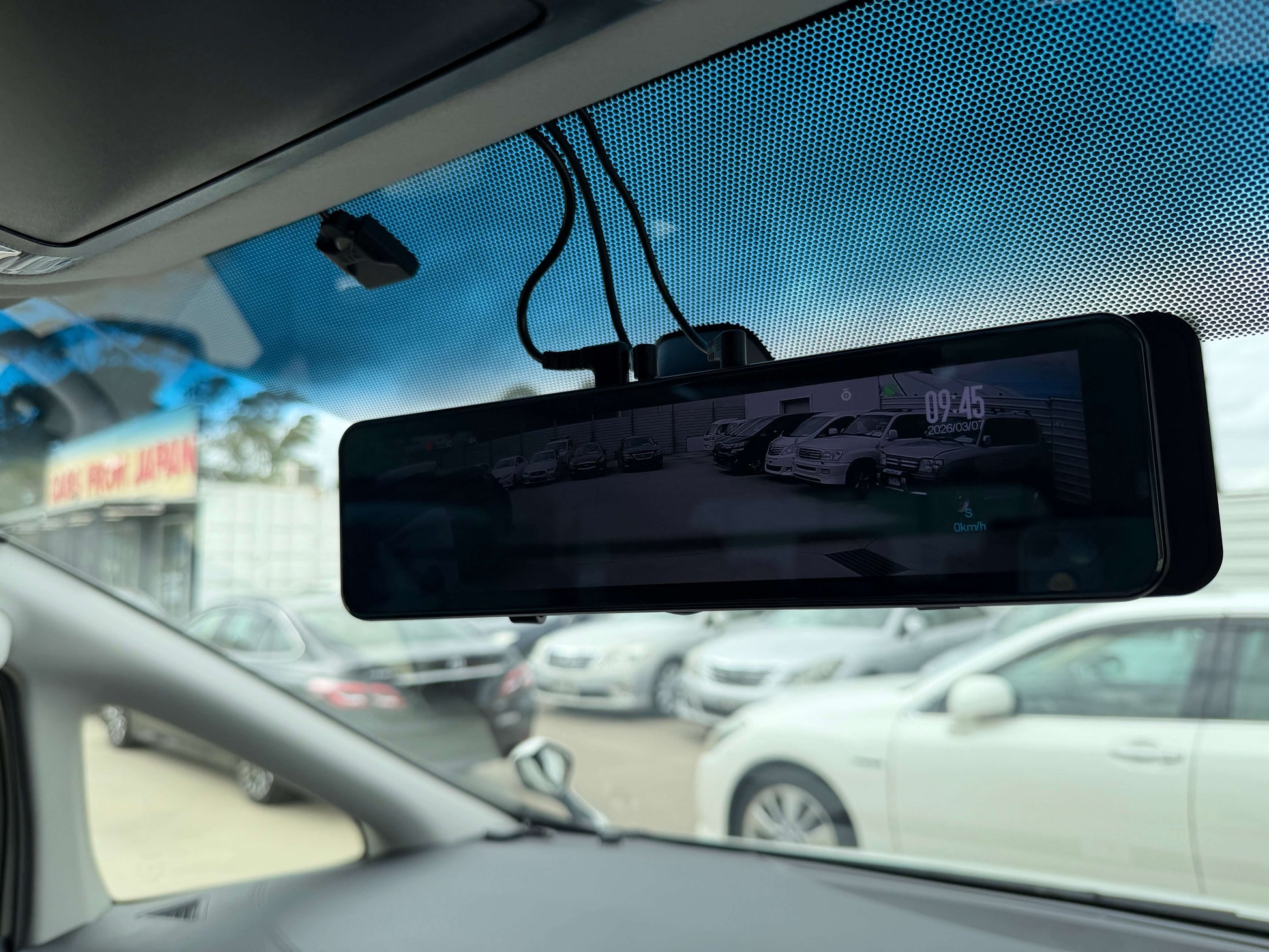 2016 Toyota Alphard 2.5L Interior view of a car showing a rearview mirror display with cars visible behind, enhancing safety and convenience.
