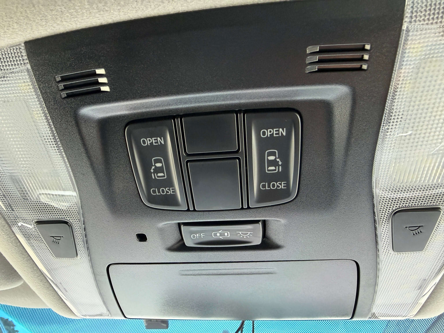 2016 Toyota Alphard 2.5L Ceiling control panel with open and close buttons in a vehicle interior.