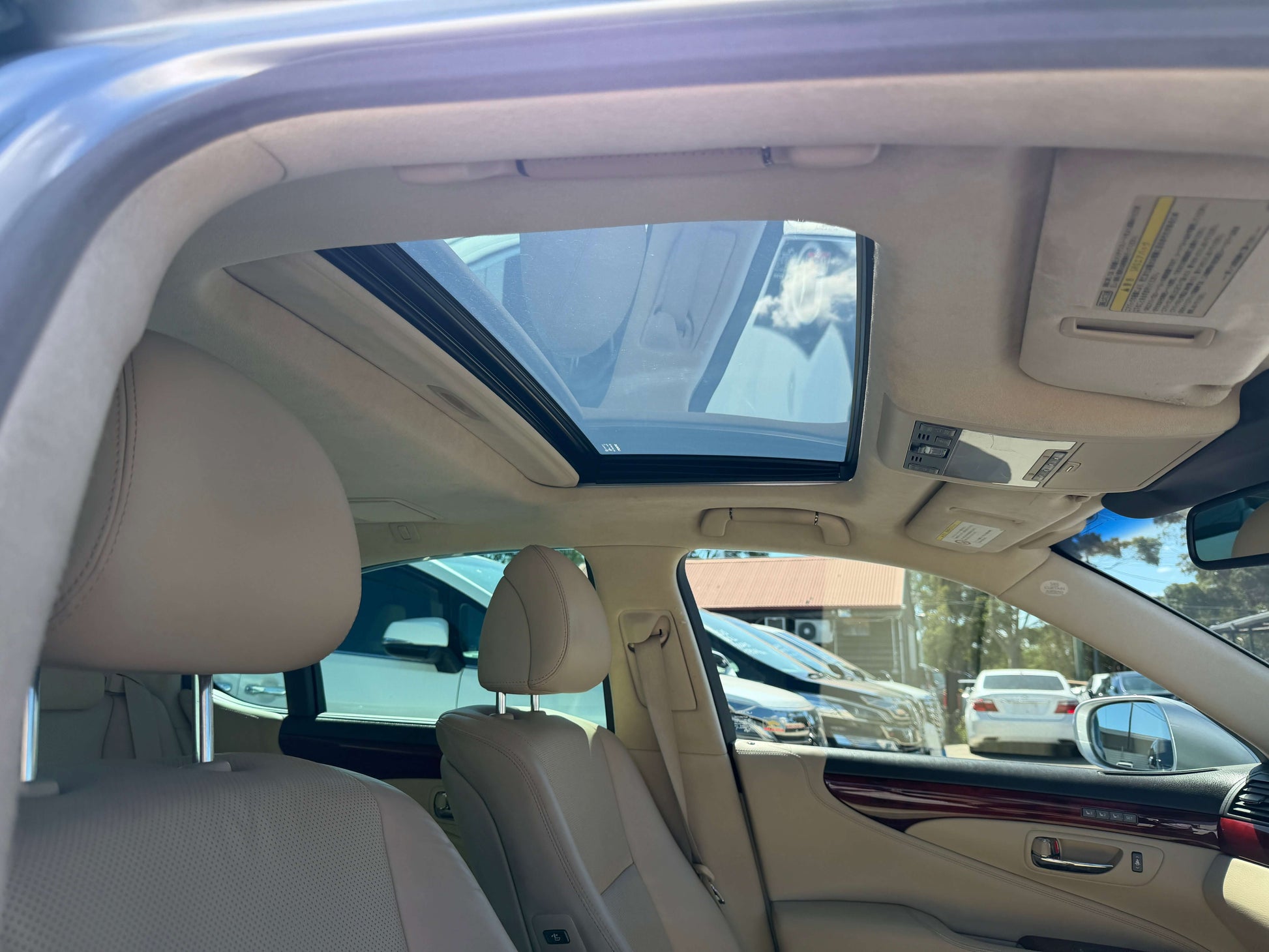 Interior view of 2010 Lexus LS460 AWD V8 4.6L showing sunroof and luxury seating.
