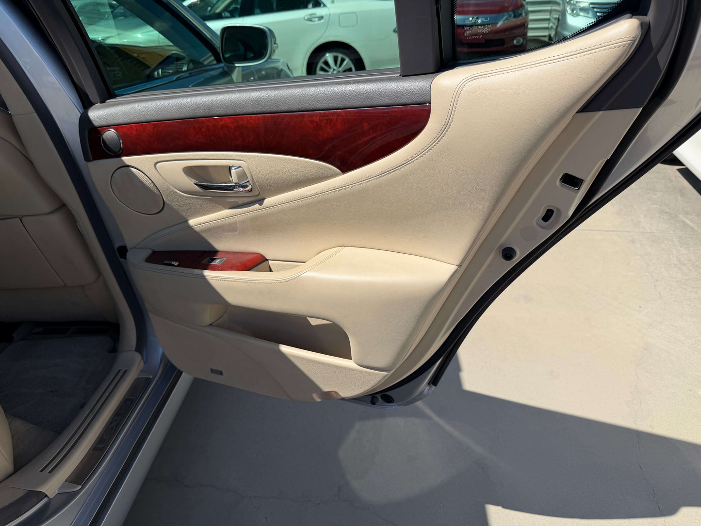 Interior view of 2010 Lexus LS460 AWD V8 4.6L door with premium leather and wood trim details.