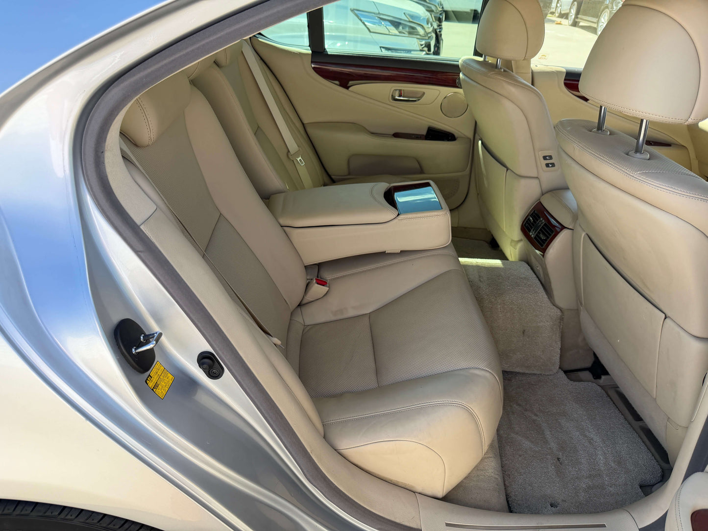 Interior view of the backseat of a 2010 Lexus LS460 AWD V8 4.6L showing premium leather seating.