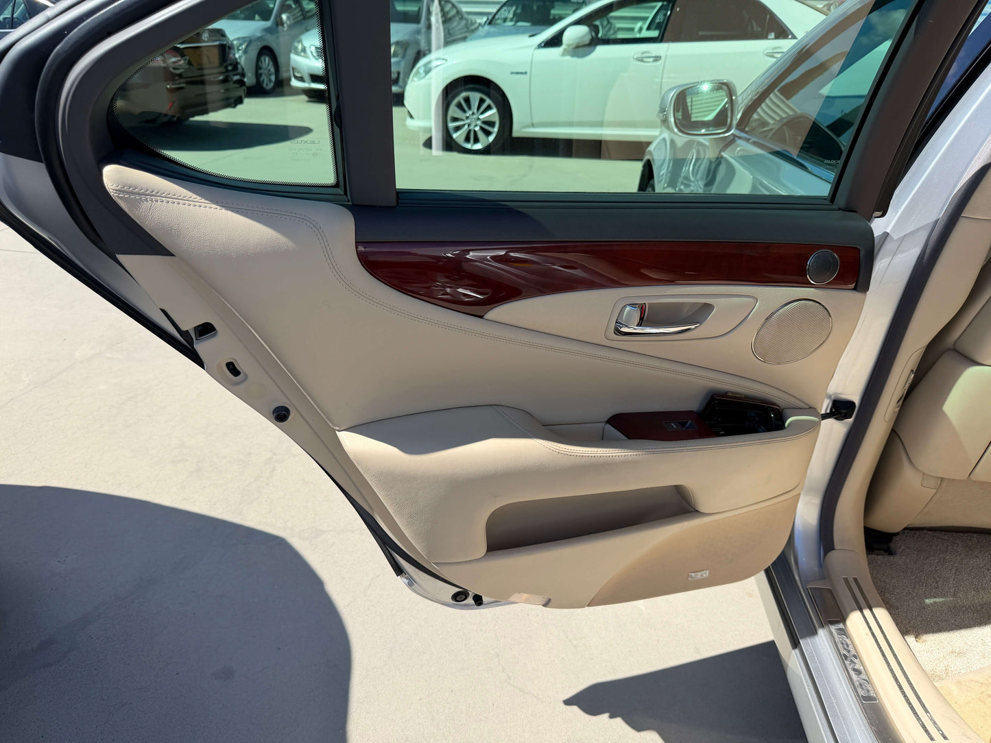Interior door panel of a 2010 Lexus LS460 AWD V8 4.6L showing luxury detailing and trim.