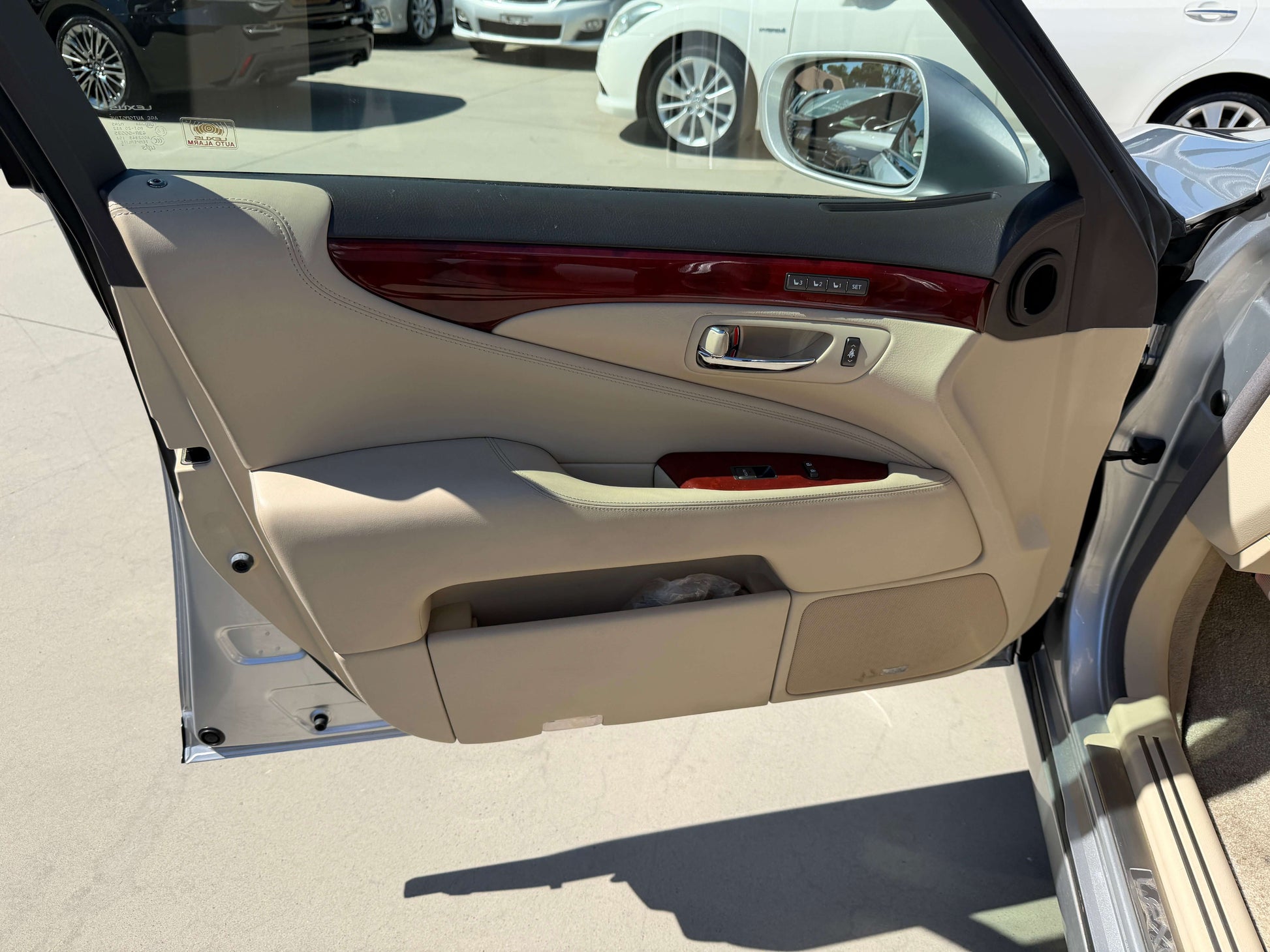 Interior view of the 2010 Lexus LS460 AWD V8 4.6L luxury sedan showing the door panel with premium finishes.