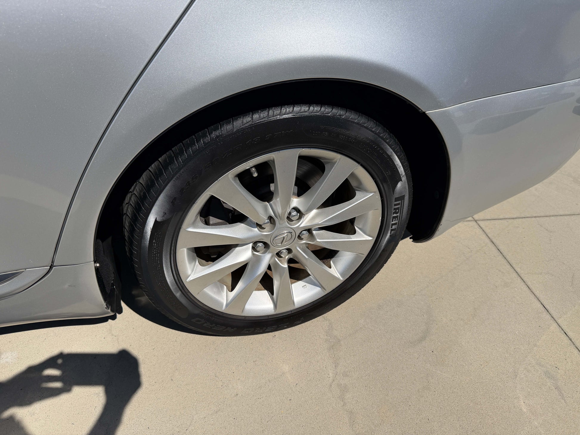 Close-up of the alloy wheel and tire on a silver 2010 Lexus LS460 AWD V8 4.6L Premium Luxury Sedan.