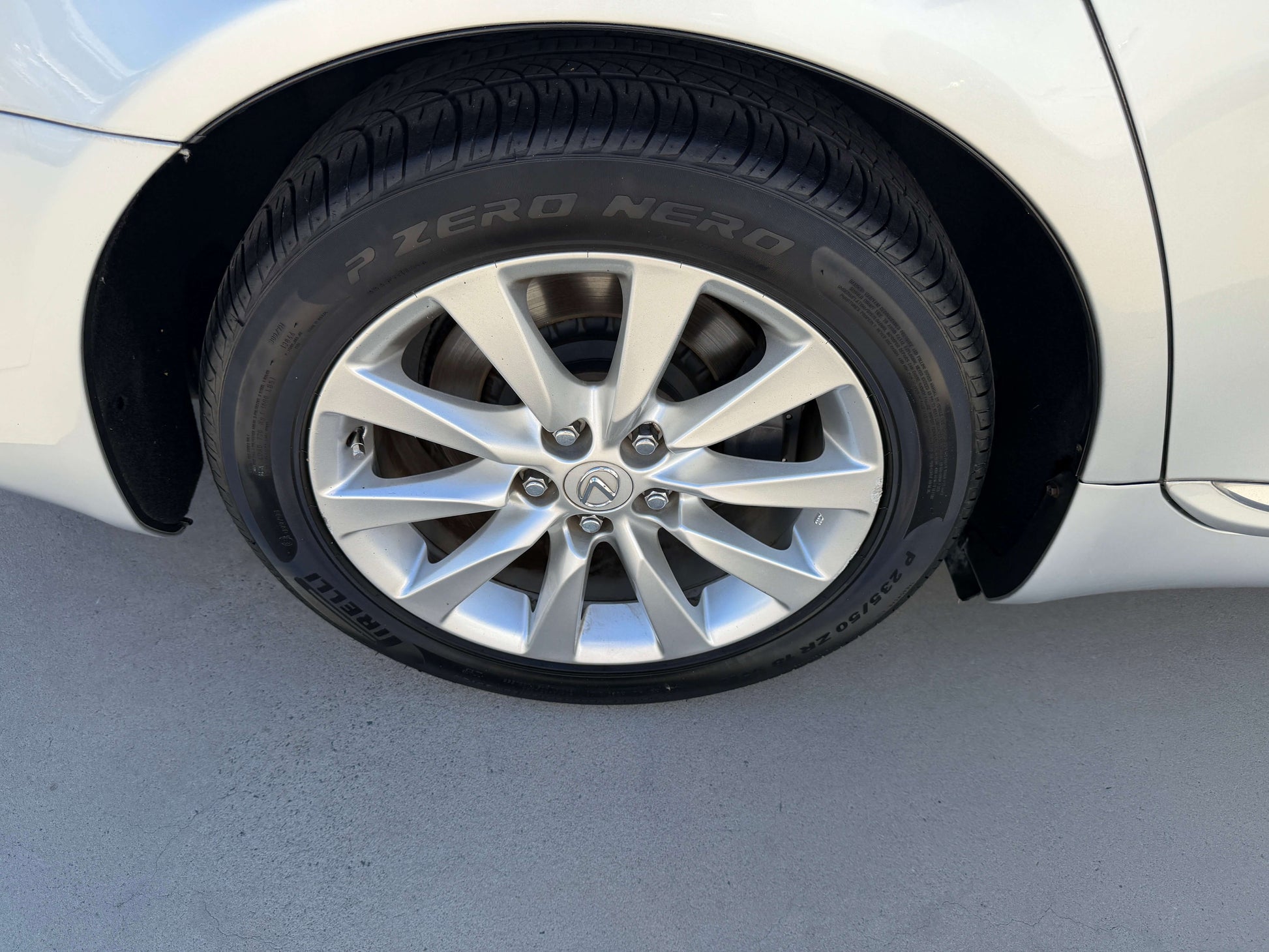 Close-up of the tire and alloy wheel of a 2010 Lexus LS460 AWD V8 4.6L, showcasing premium design and performance.