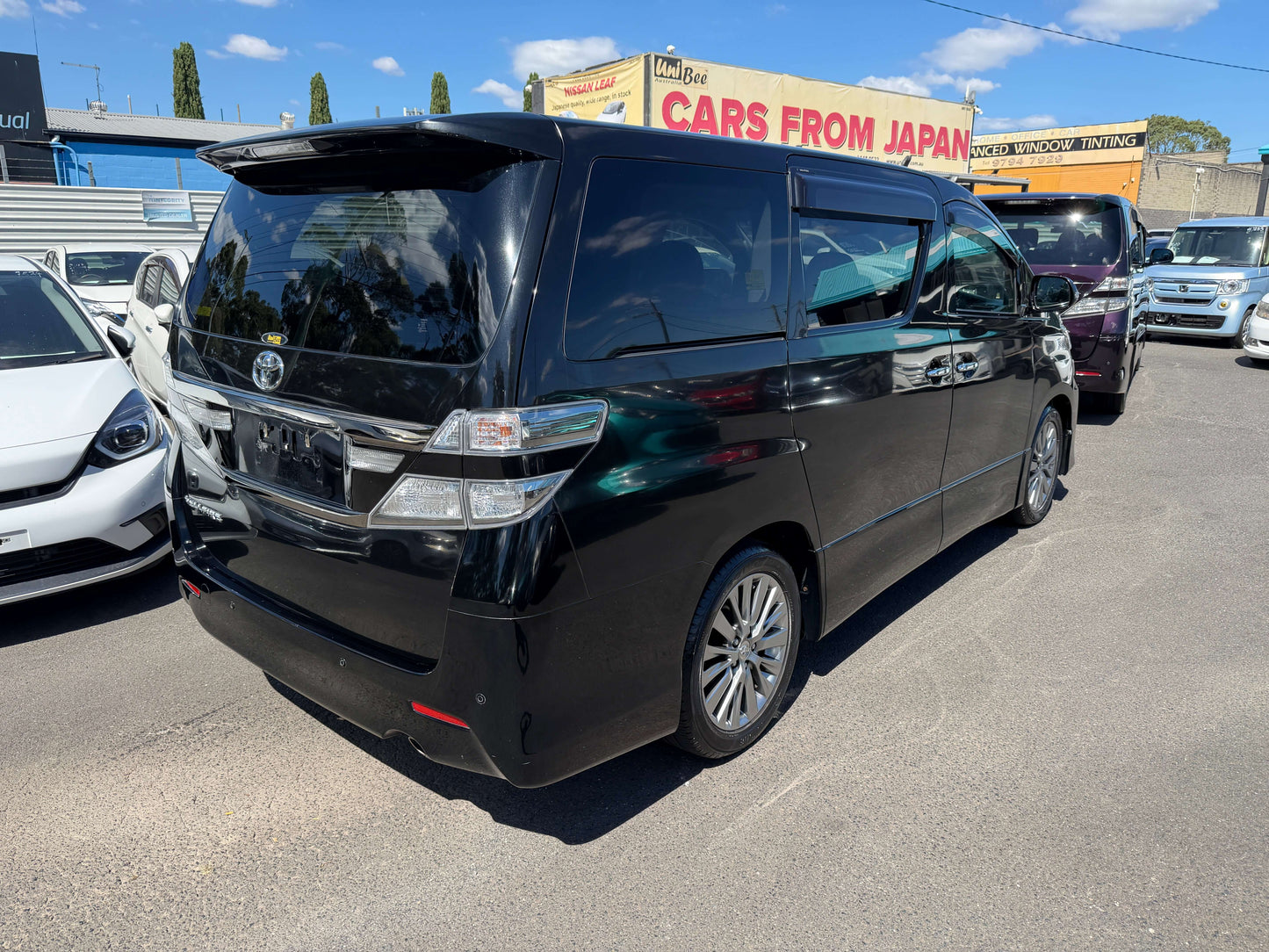 2013 Toyota Vellfire 2.4L Z Golden Eyes Edition black rear view showcasing 7 seats and sleek design.