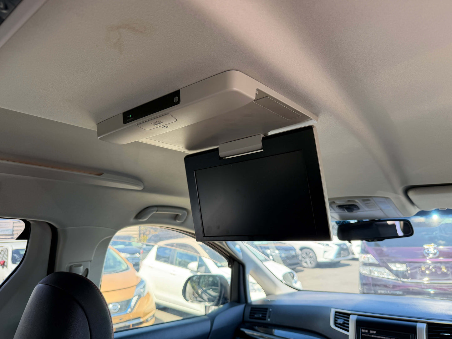 2013 Toyota Vellfire 2.4L interior view with overhead screen for entertainment in 7-seat configuration