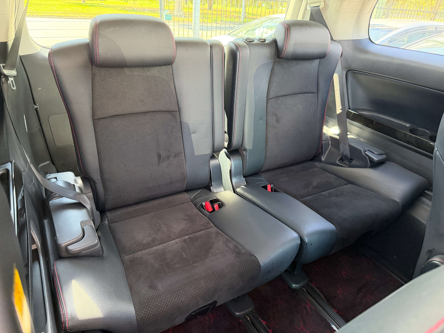 Interior view of the back seats of a 2013 Toyota Vellfire 2.4L Z Golden Eyes Edition, featuring 7 seats arrangement.