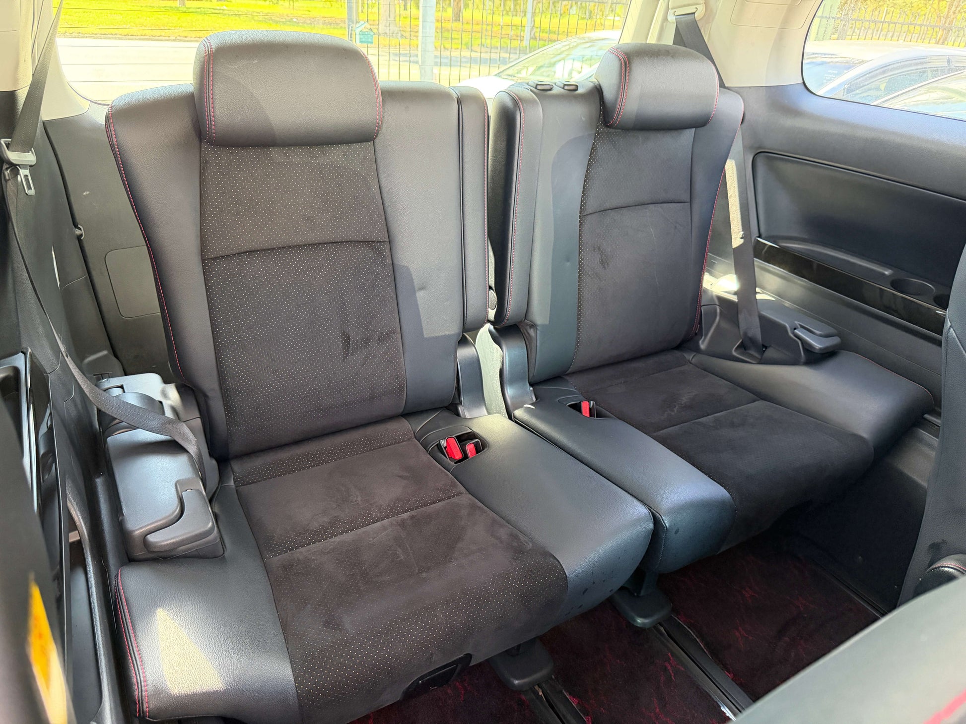 Interior view of the back seats of a 2013 Toyota Vellfire 2.4L Z Golden Eyes Edition, featuring 7 seats arrangement.