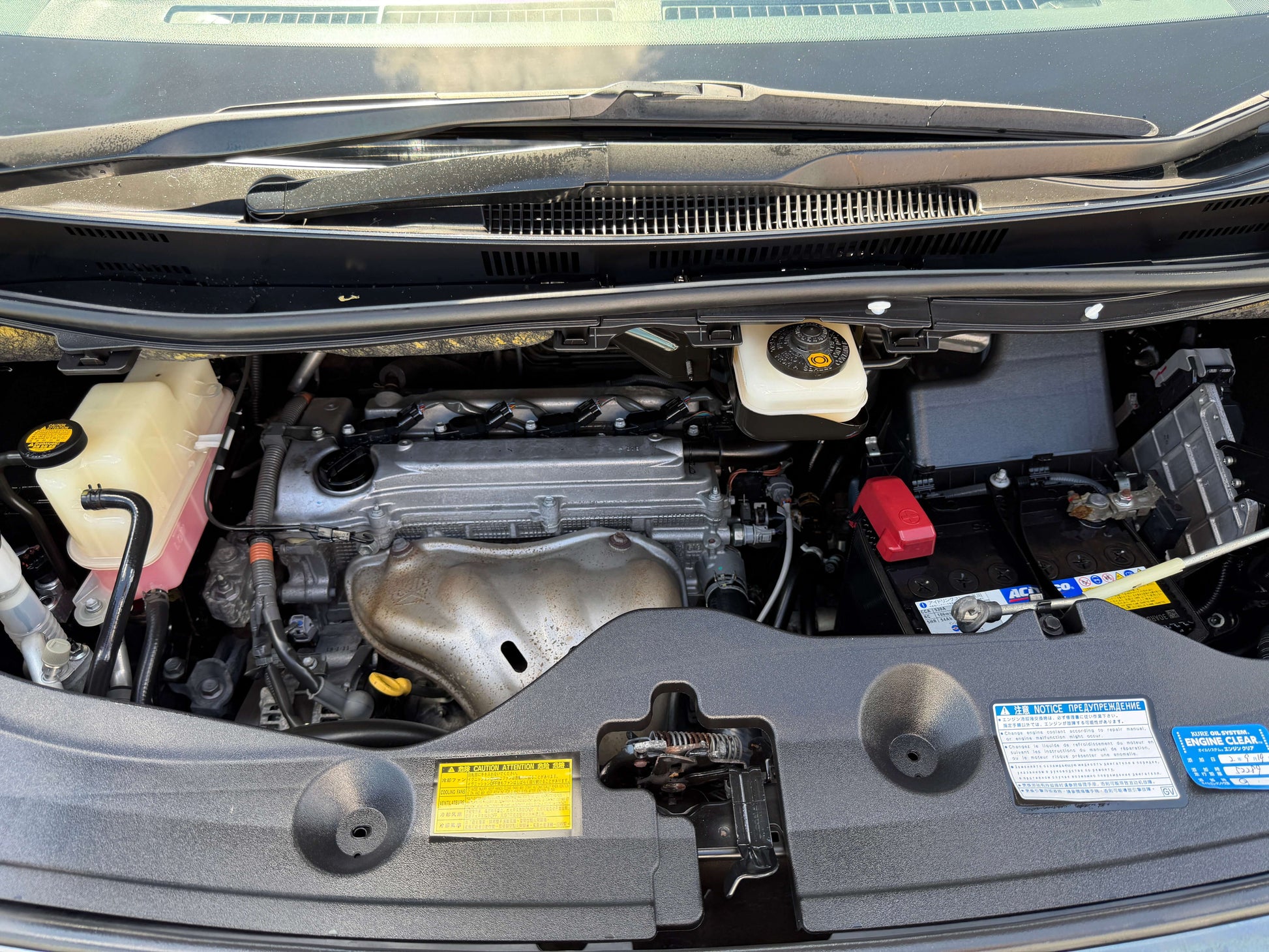 2013 Toyota Vellfire 2.4L engine compartment with components visible under the hood, showcasing vehicle maintenance area.