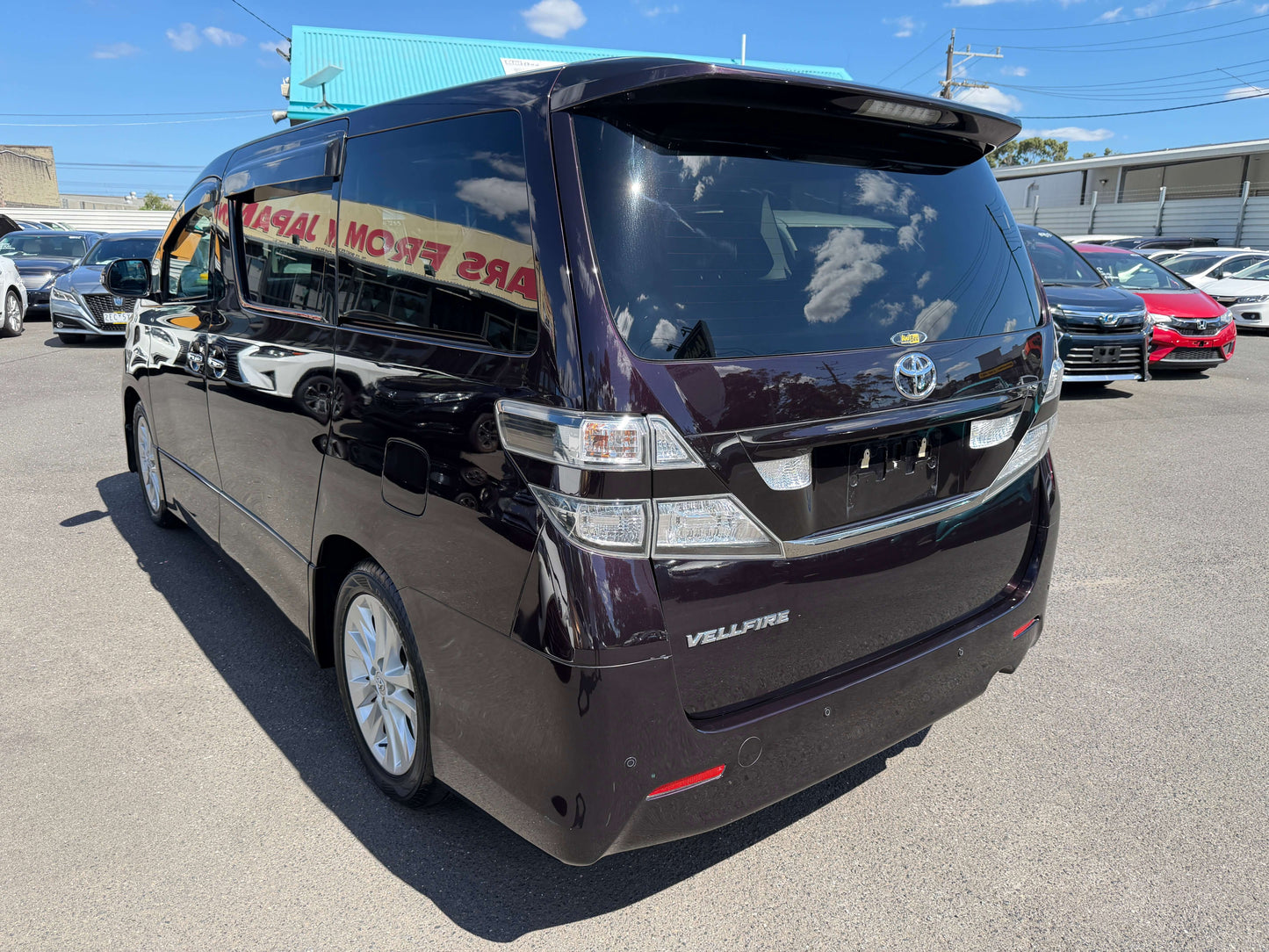 2009 Toyota Vellfire 2.4L Z Edition rear view in a car lot, showcasing its luxury design and 7-seat capacity.