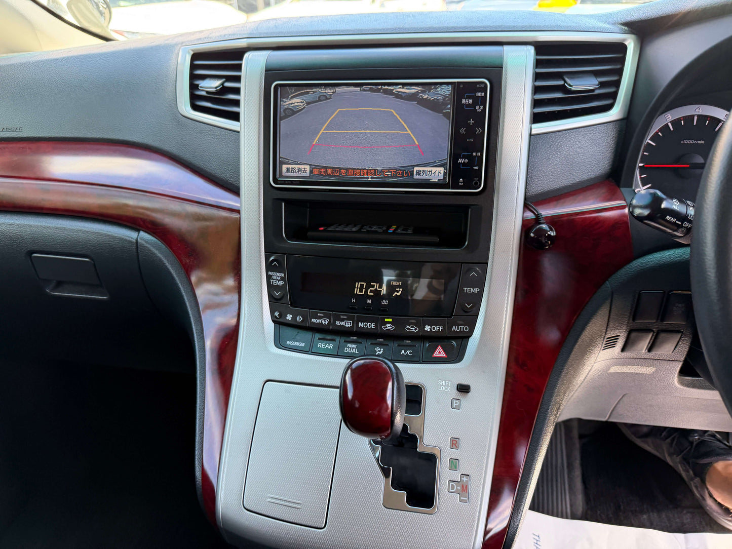 Interior dashboard of 2009 Toyota Vellfire 2.4L showing touchscreen display and gear shift.