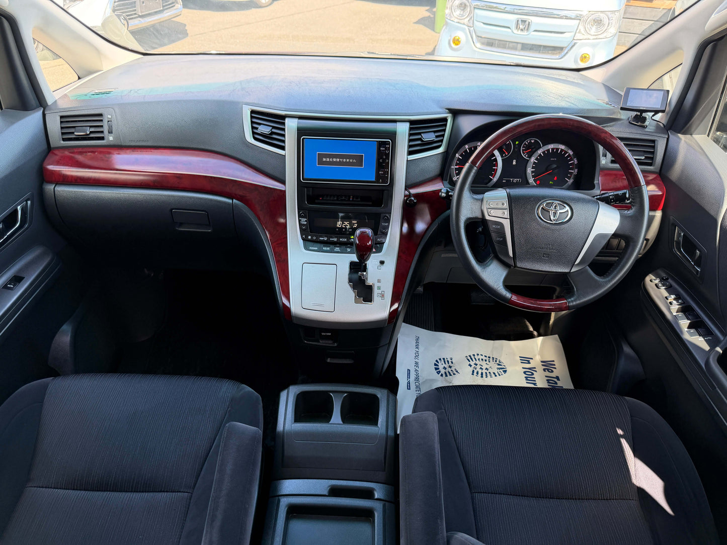 Interior view of a 2009 Toyota Vellfire 2.4L Z Edition showcasing dashboard and seats.