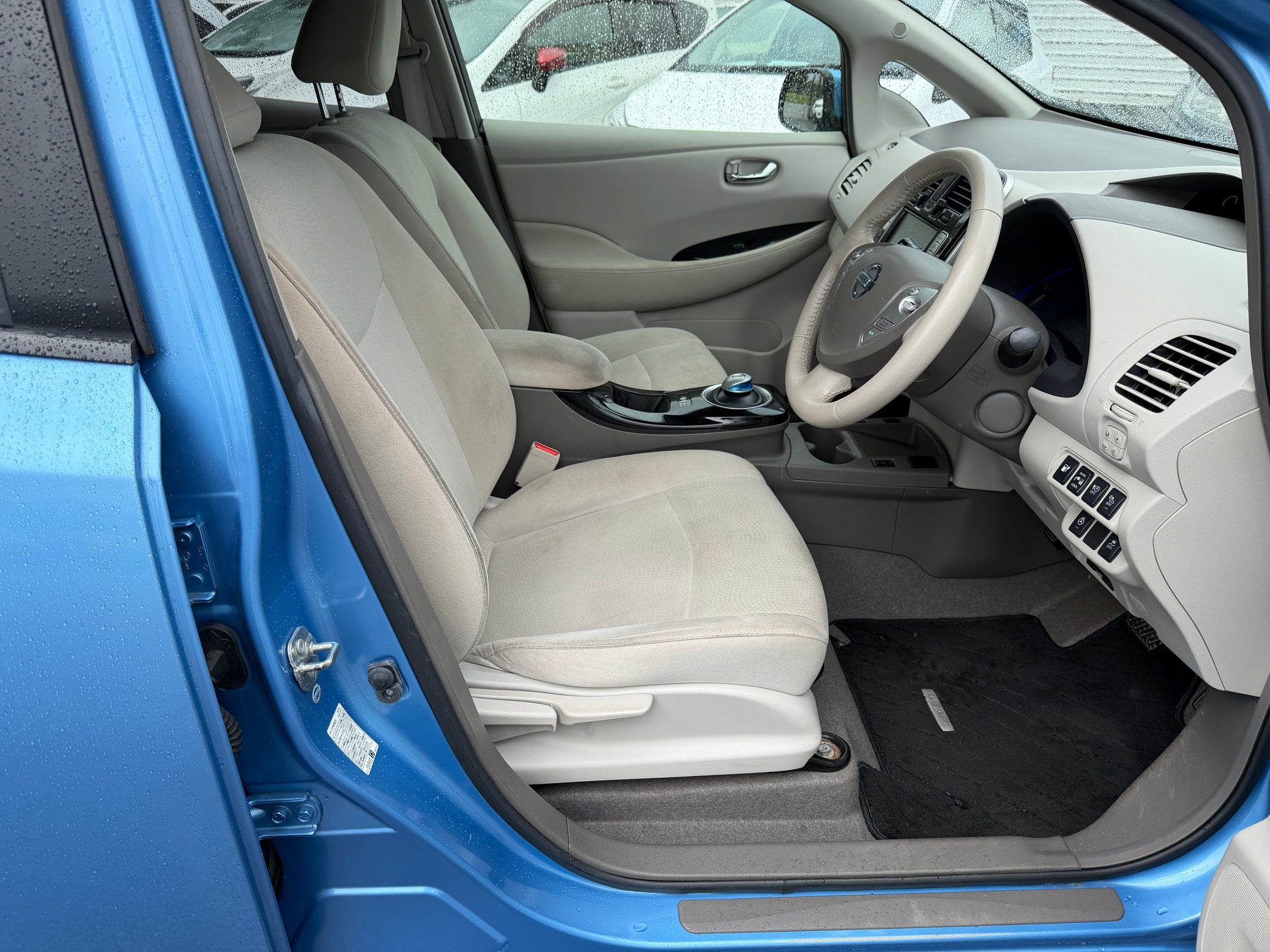 Interior view of a 2015 Nissan Leaf 24kW G-Edition Full Electric showcasing comfortable seating and modern dashboard design.