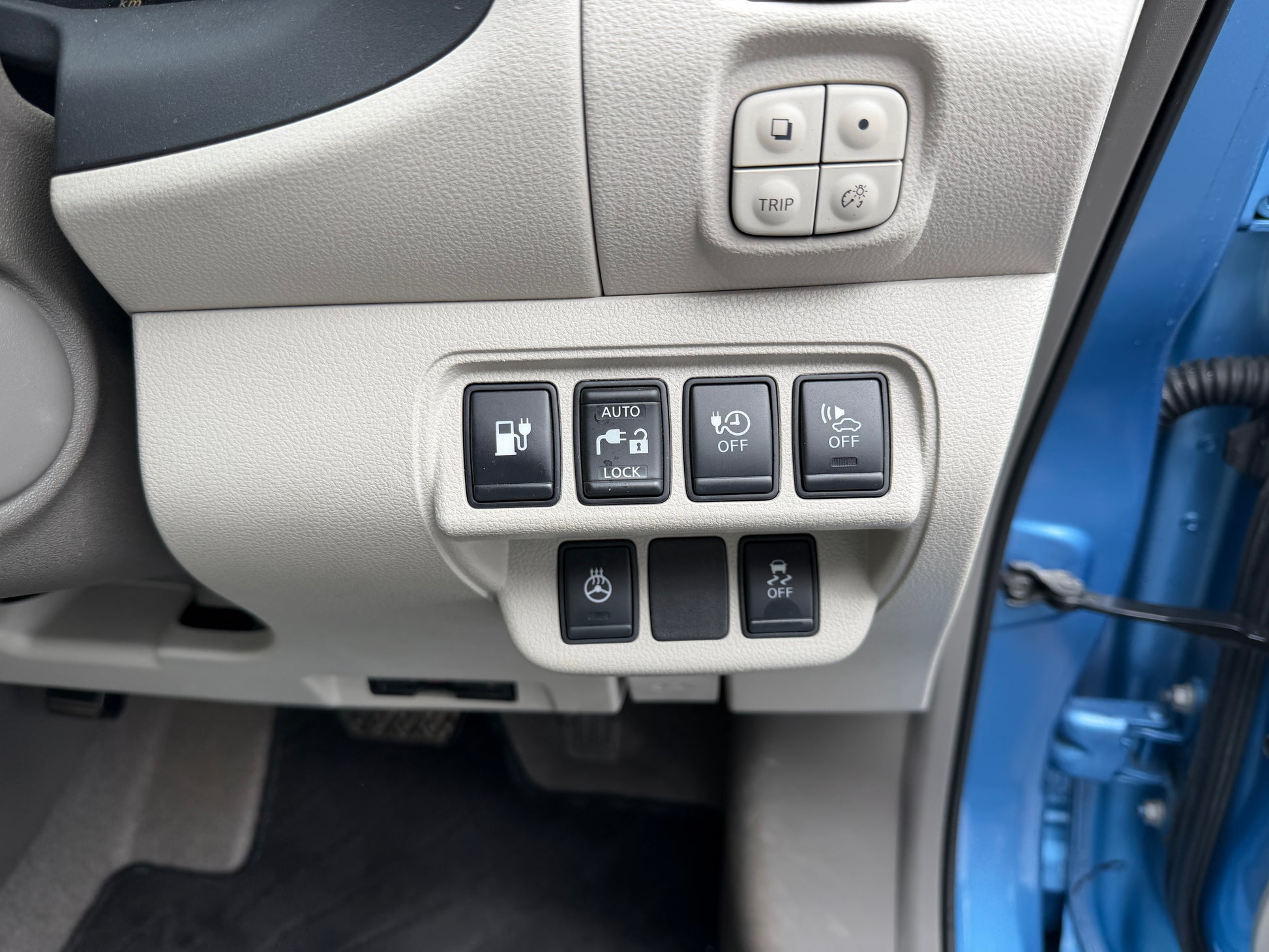 Control panel with buttons for the 2015 Nissan Leaf 24kW G-Edition Full Electric, enhancing functionality and technology.