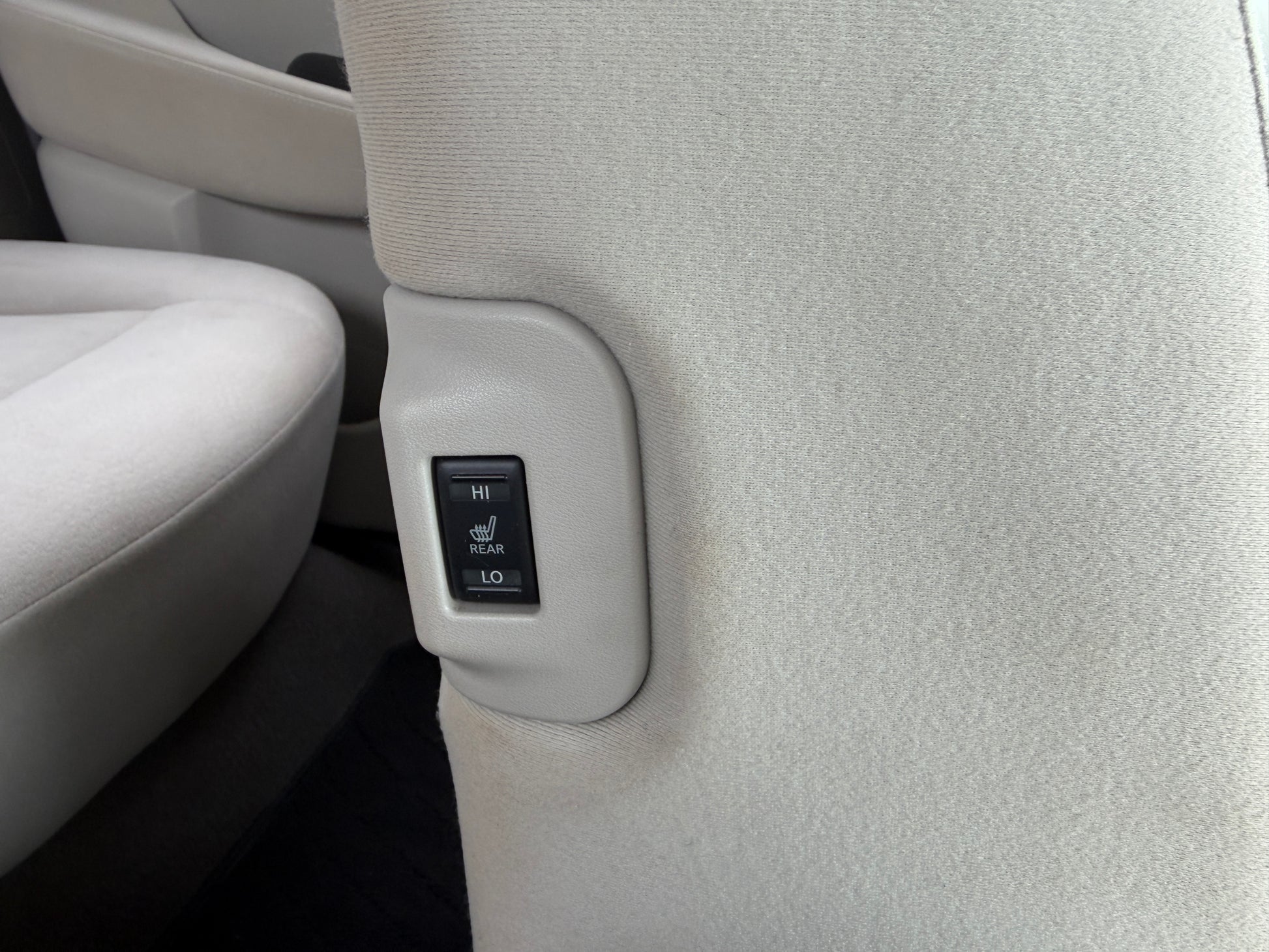 Rear seat heating control button in a 2015 Nissan Leaf 24kW G-Edition Full Electric interior.