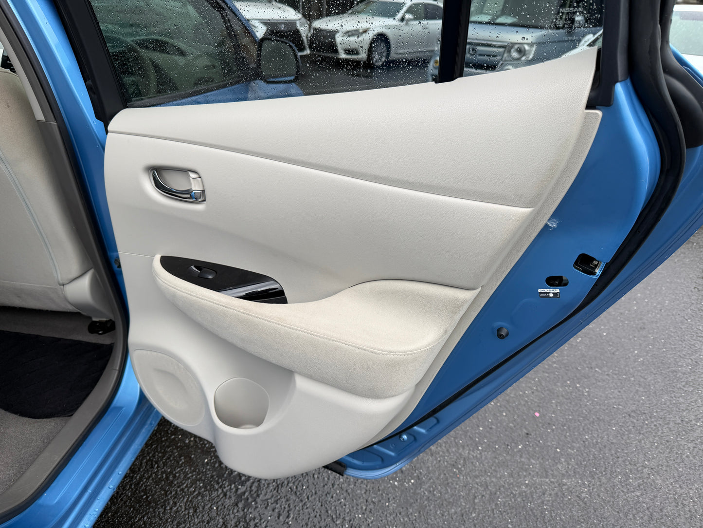 Interior view of the 2015 Nissan Leaf 24kW G-Edition Full Electric door panel showing sleek design and features.