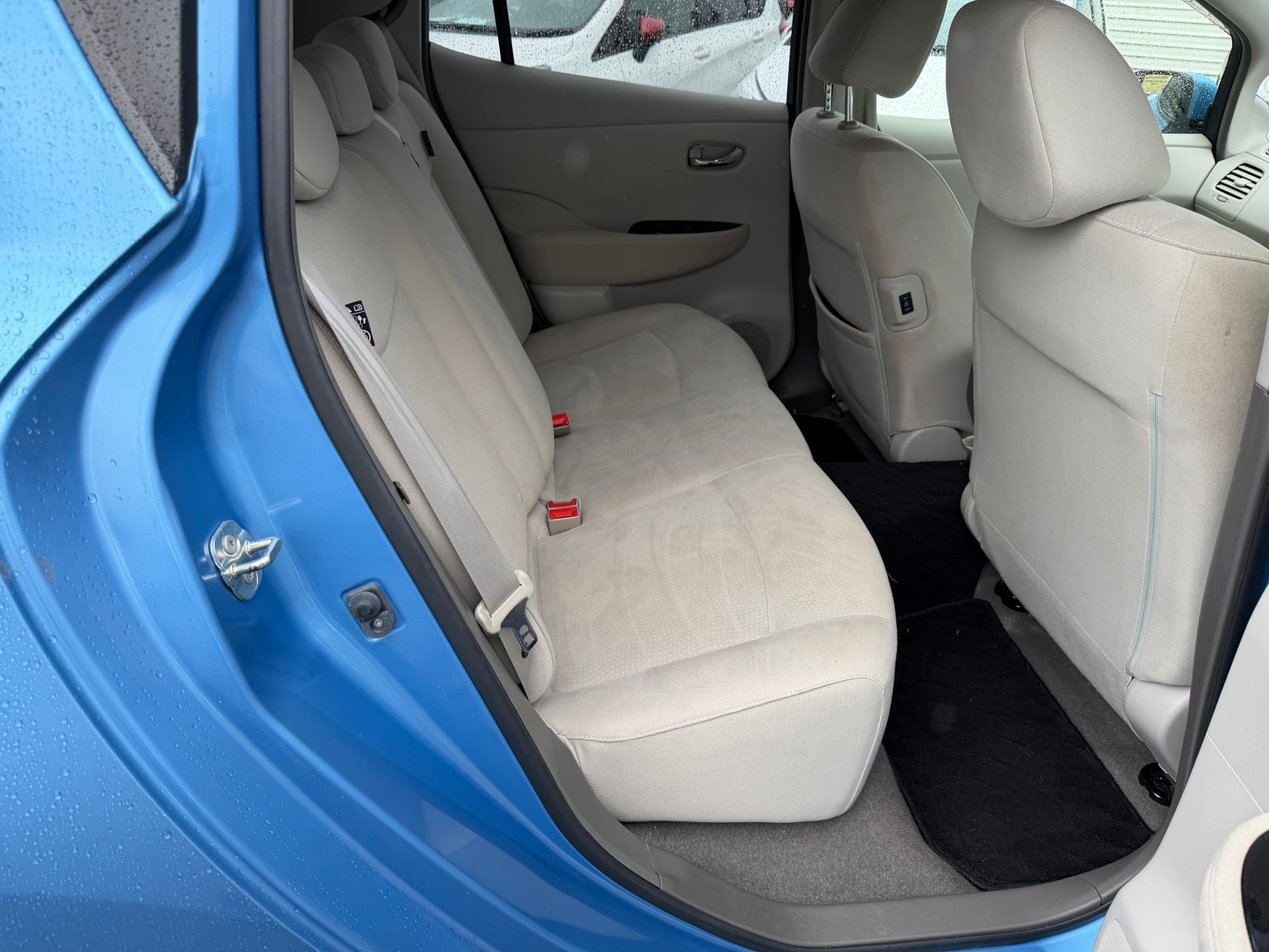 Interior view of the back seat of a 2015 Nissan Leaf 24kW G-Edition Full Electric showing spacious seating.