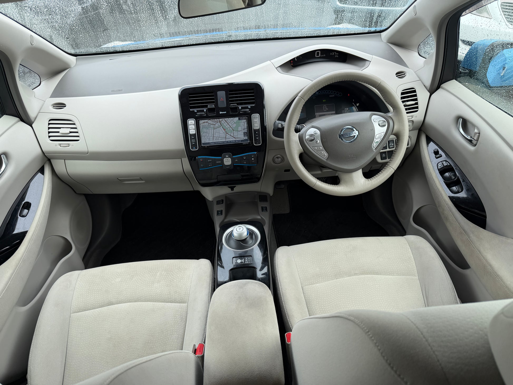 Interior view of a 2015 Nissan Leaf 24kW G-Edition Full Electric showcasing sleek design and advanced technology.