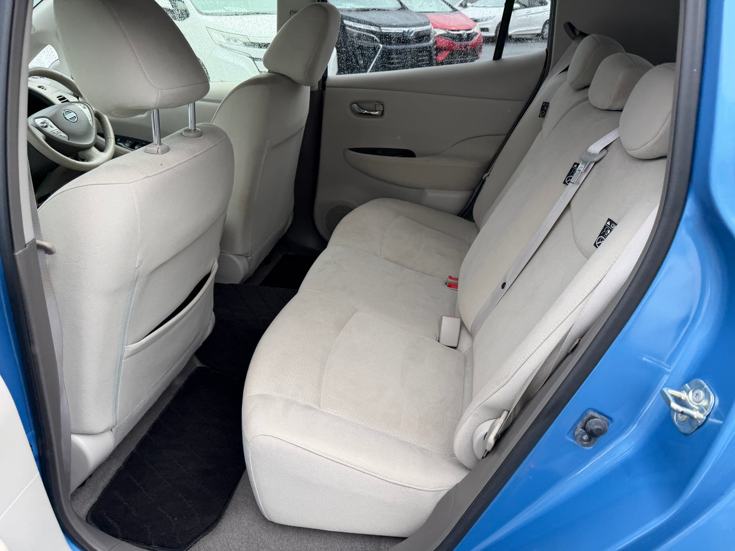 Interior view of the back seat of a 2015 Nissan Leaf 24kW G-Edition Full Electric, showcasing spacious seating.