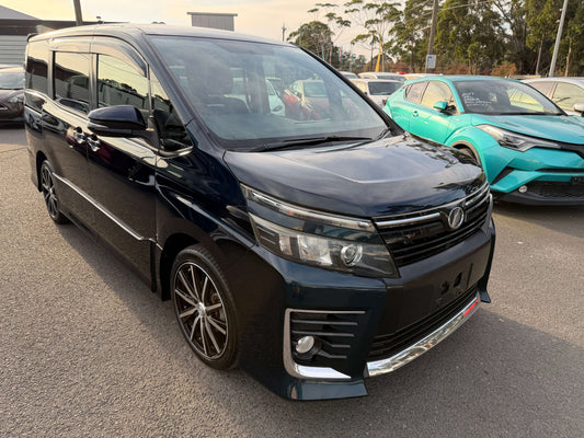 2014 Toyota Voxy 2.0L ZS Premium Edition 7 seater parked in a lot, showcasing sleek black exterior and modern design.