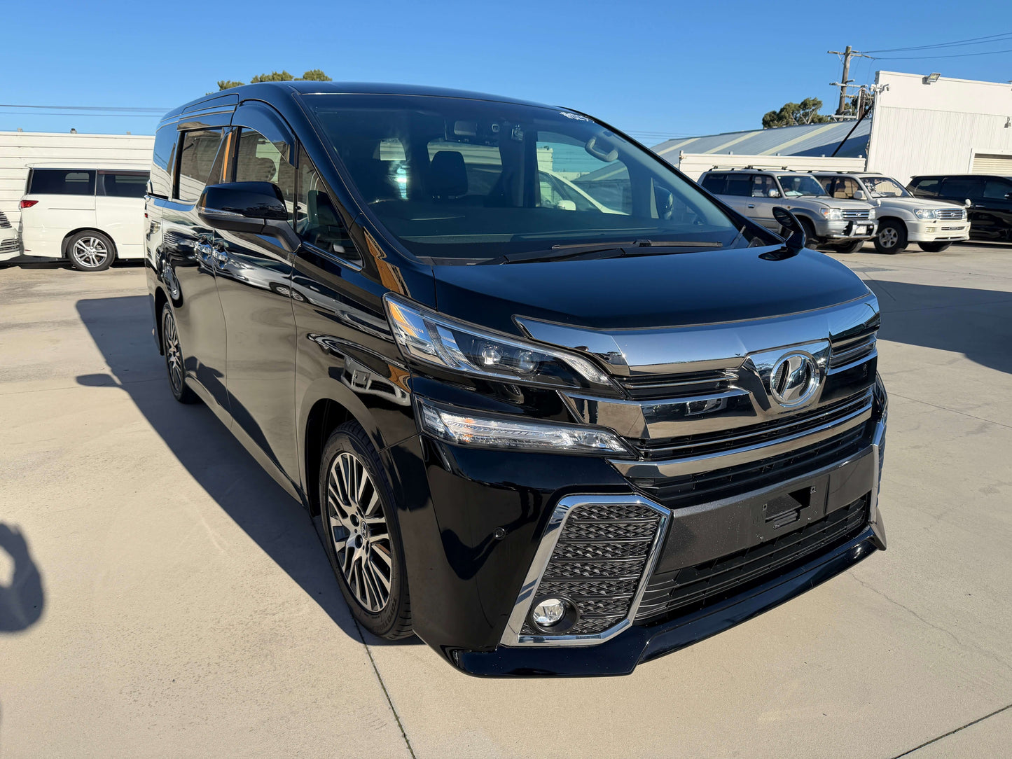 2016 Toyota Vellfire V6 3.5L in black color, luxury people mover parked on a sunny day.