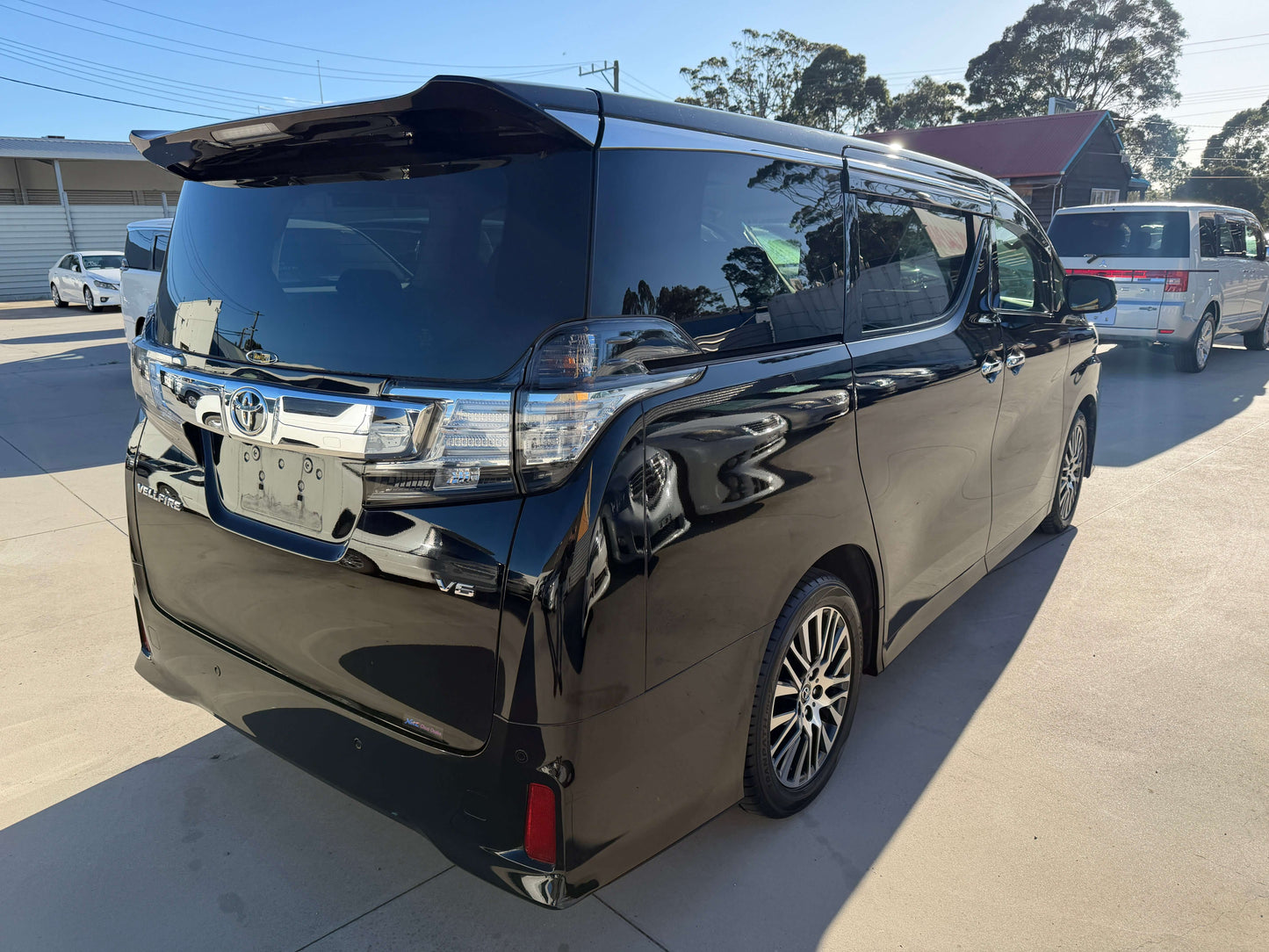 2016 Toyota Vellfire V6 3.5L luxury people mover rear view, showcasing sleek black exterior and modern design.