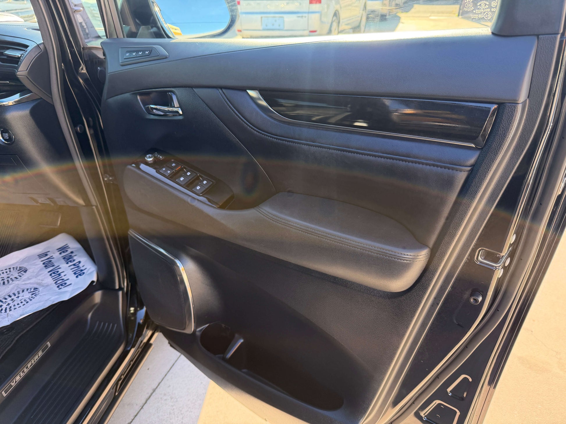 Interior view of the 2016 Toyota Vellfire V6 3.5L showing the driver's side door features and controls.