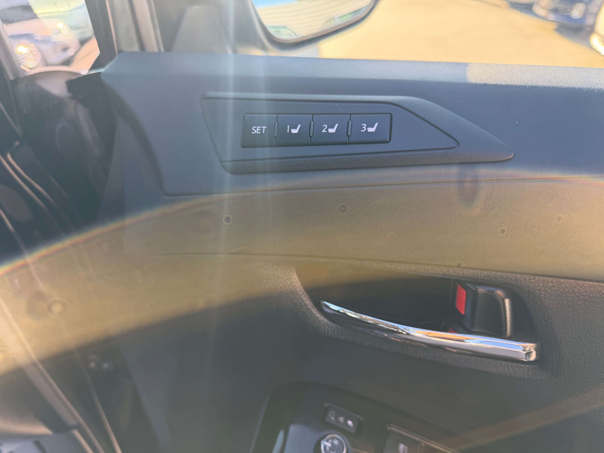 Interior detail of the 2016 Toyota Vellfire V6 3.5L showing the seat memory buttons on the door panel.