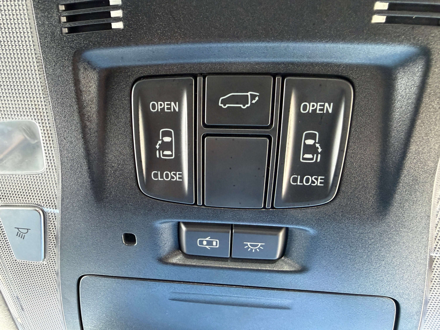 Control panel showing buttons labeled OPEN and CLOSE for doors in a 2016 Toyota Vellfire V6 3.5L.