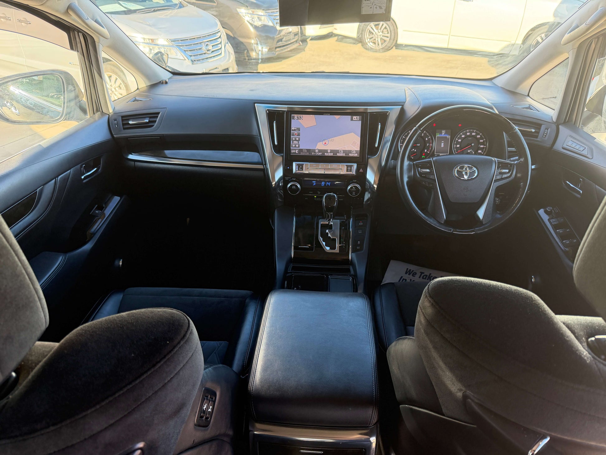Interior view of a 2016 Toyota Vellfire V6 3.5L showing dashboard and seating arrangements.