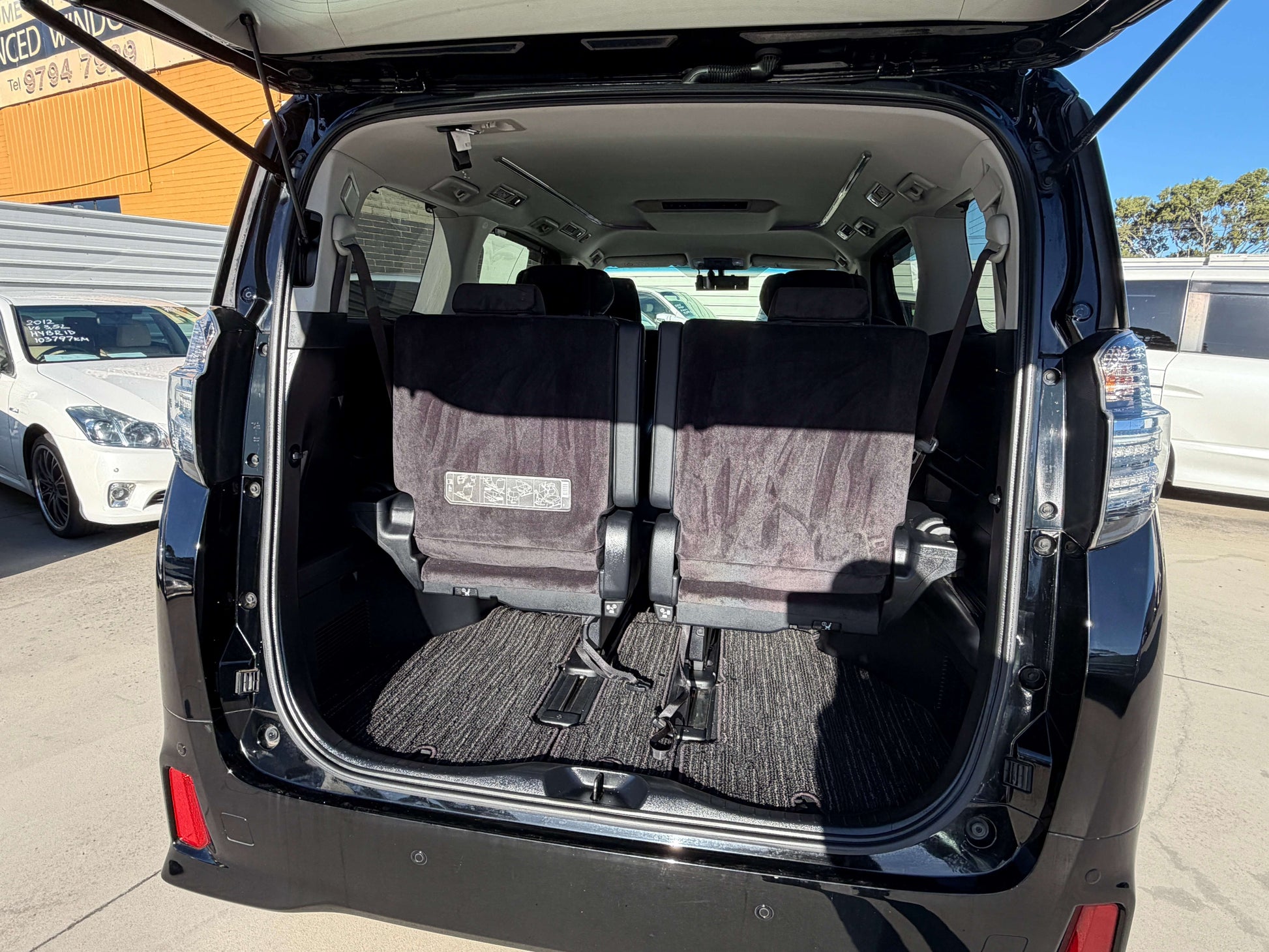 Interior view of the spacious rear seating area in the 2016 Toyota Vellfire V6 3.5L, highlighting the 7 seats and luxury design.