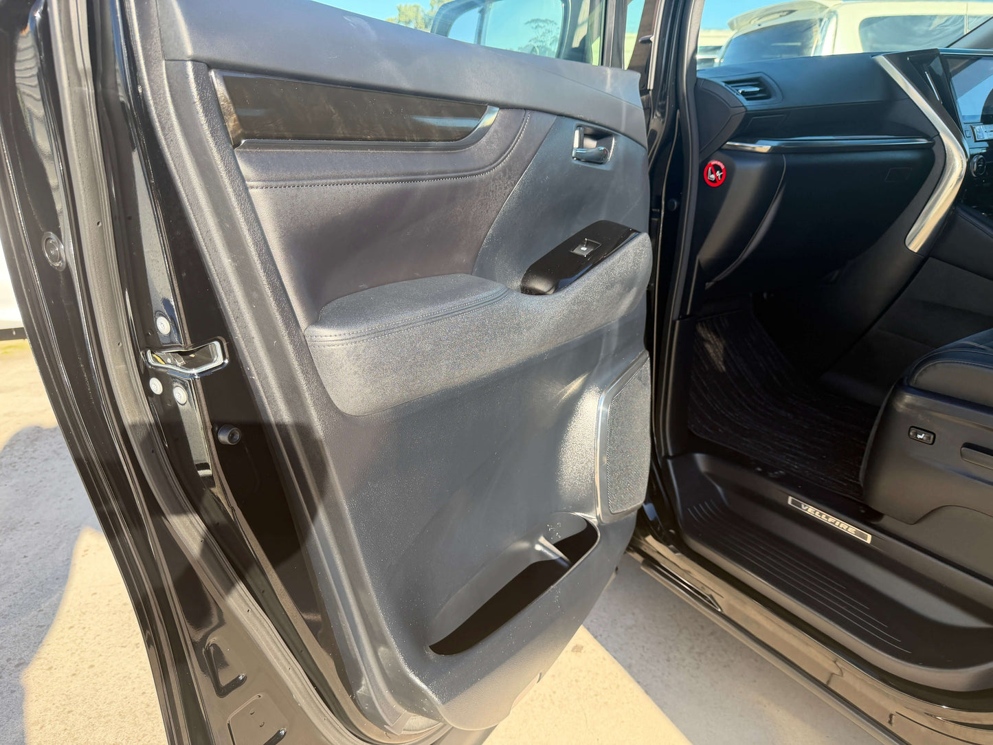 Interior view of 2016 Toyota Vellfire V6 3.5L door panel showcasing luxury design and features.