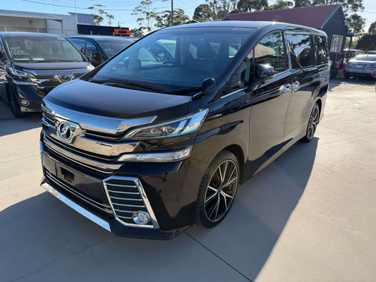 2016 Toyota Vellfire 2.5L Luxury People Mover, sleek black exterior, spacious 7 seats, parked on showroom floor