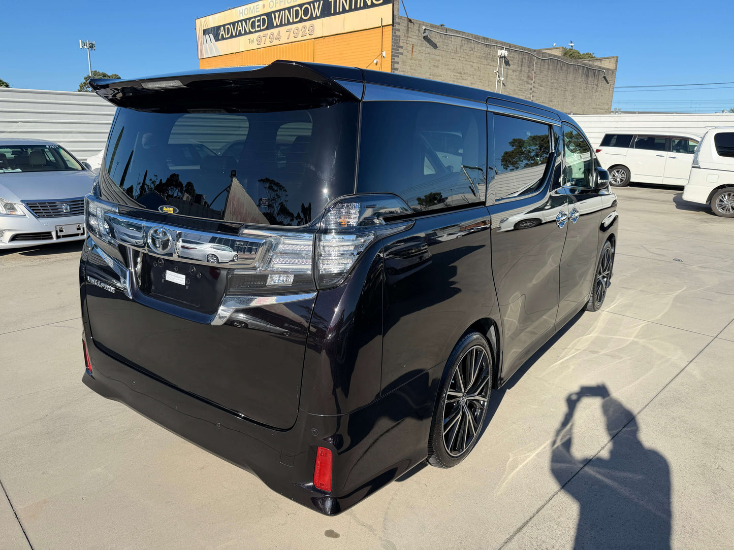 Rear view of a black 2016 Toyota Vellfire 2.5L Luxury People Mover showcasing its stylish design and sleek lines.