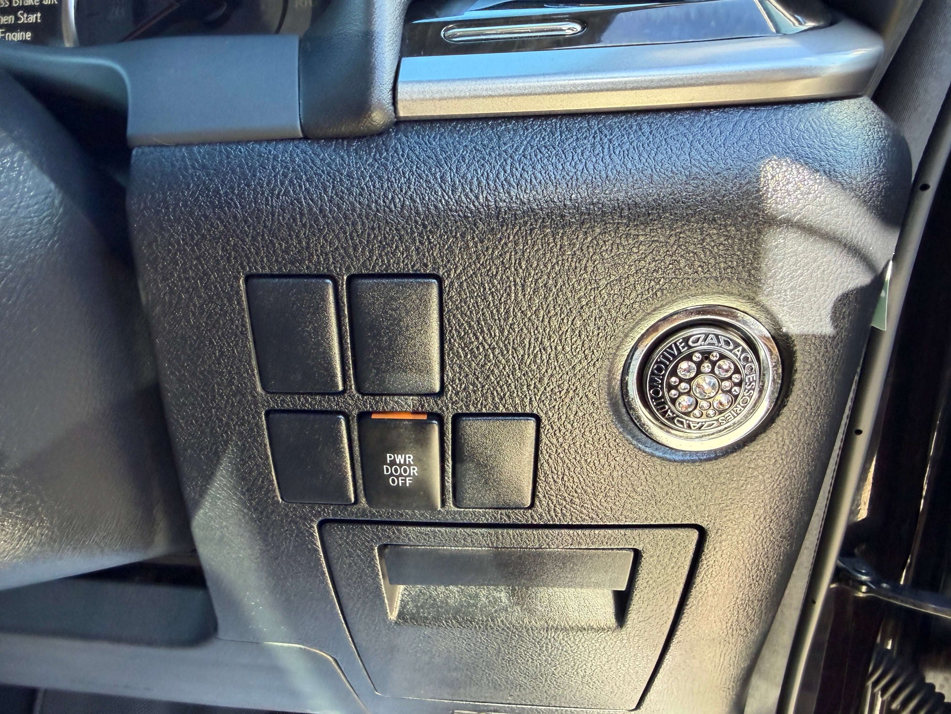 Interior control panel of a 2016 Toyota Vellfire 2.5L showing buttons and ignition key.