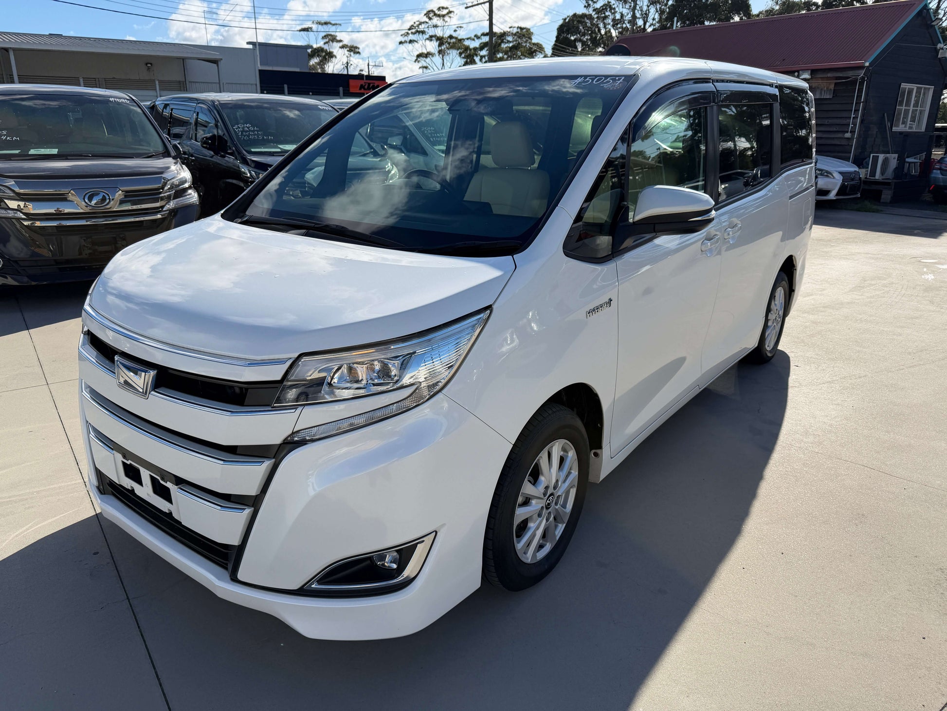 2017 Toyota Noah 1.8L Hybrid G Premium Edition 7 seater parked in showroom with clear sky.