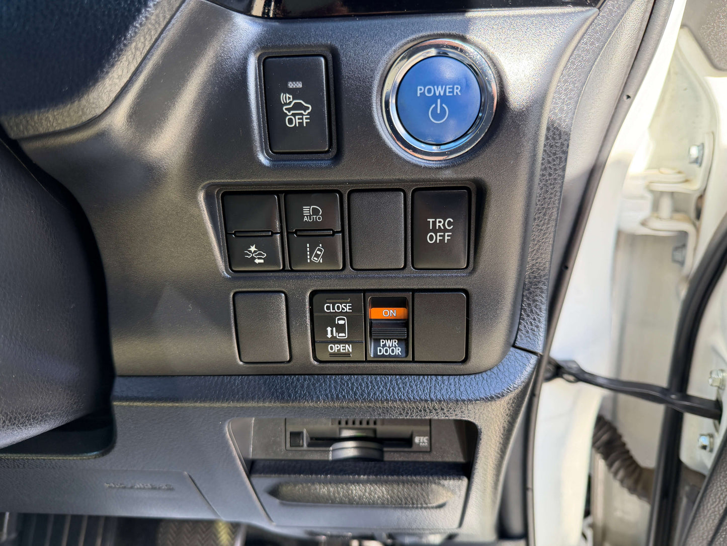 Interior control panel of a 2017 Toyota Noah 1.8L Hybrid with various buttons and a power button.