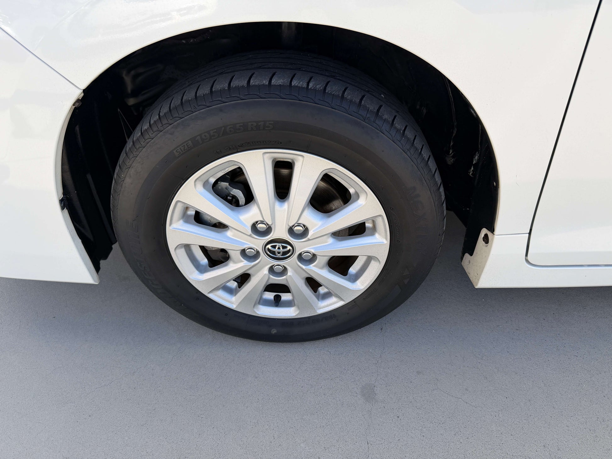 Wheel of a 2017 Toyota Noah 1.8L Hybrid showing alloy rim and tire close-up.