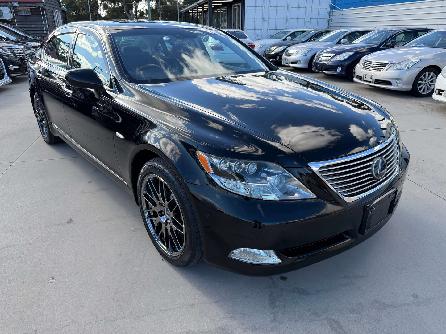 2007 Lexus LS600hL AWD V8 5.0L Hybrid luxury sedan in black, front view, parked among other vehicles.