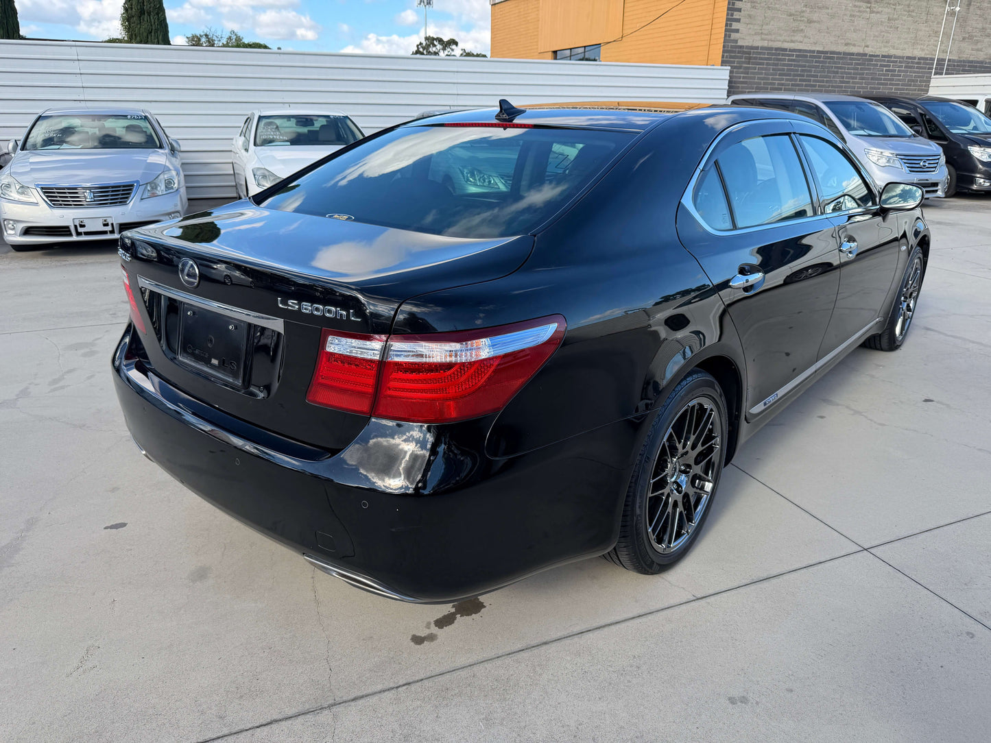 2007 Lexus LS600hL AWD V8 5.0L Hybrid luxury sedan showcased from the rear angle in a parking lot.