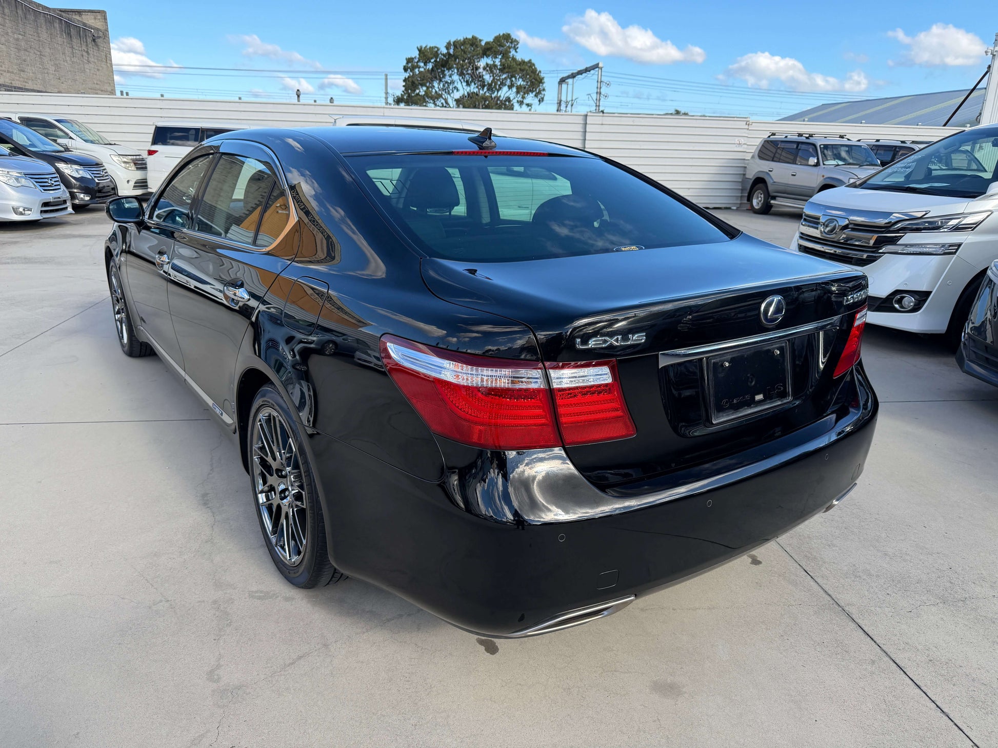 2007 Lexus LS600hL AWD V8 5.0L Hybrid luxury sedan, rear view in black color, showcasing stylish design and modern aesthetics.