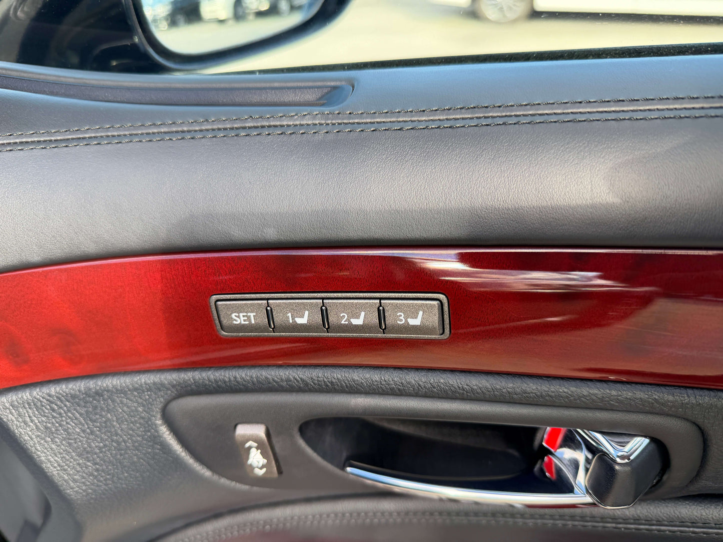 2007 Lexus LS600hL AWD V8 5.0L Hybrid luxury sedan interior seat adjustment buttons and wood trim.