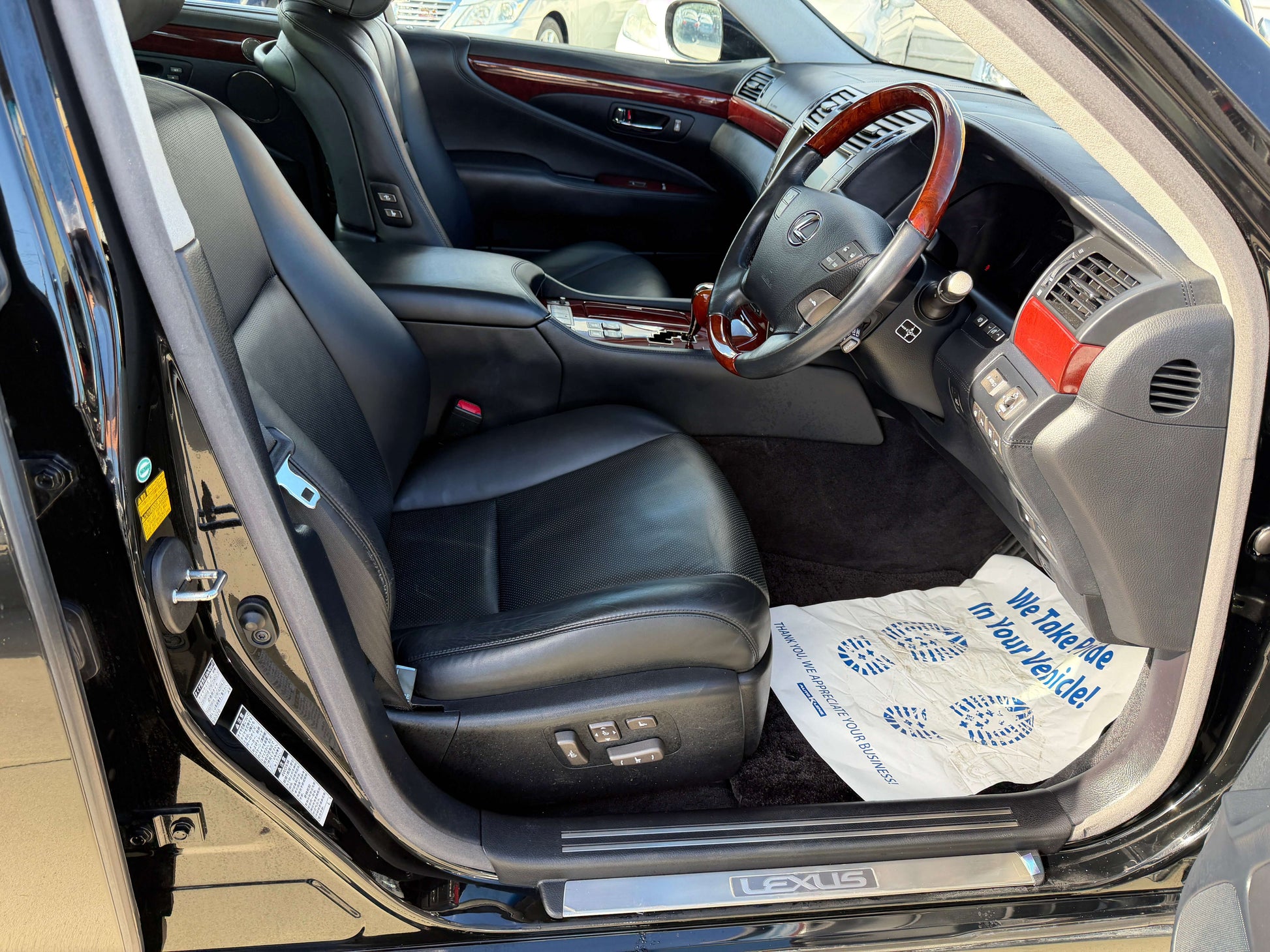 Interior view of 2007 Lexus LS600hL AWD V8 5.0L Hybrid showing luxury black leather seats and dashboard.
