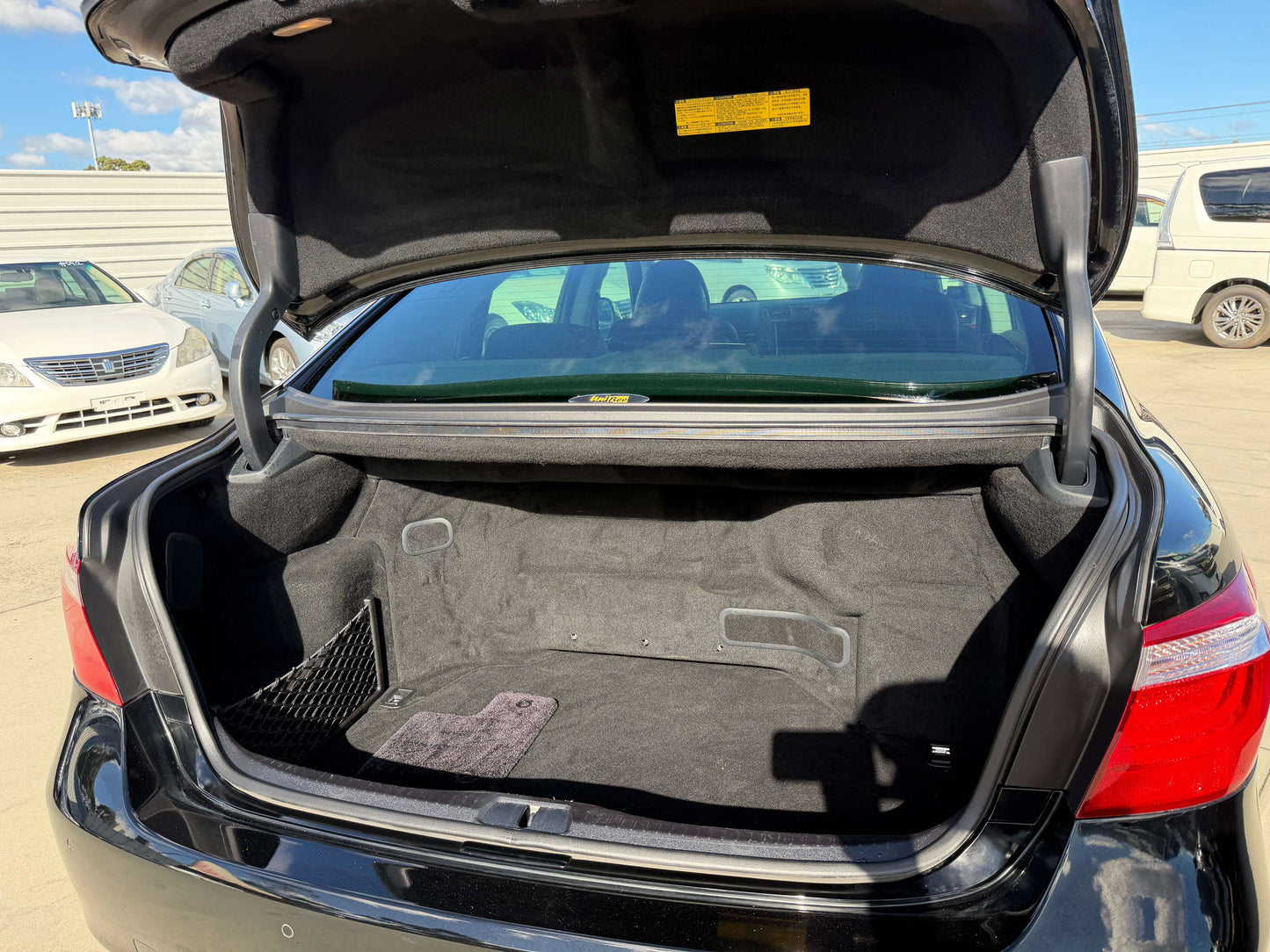 2007 Lexus LS600hL AWD V8 5.0L Hybrid trunk space with black carpet interior.