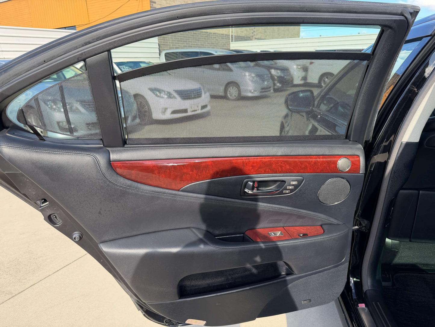 Interior view of a 2007 Lexus LS600hL AWD V8 5.0L Hybrid door panel with wood trim.