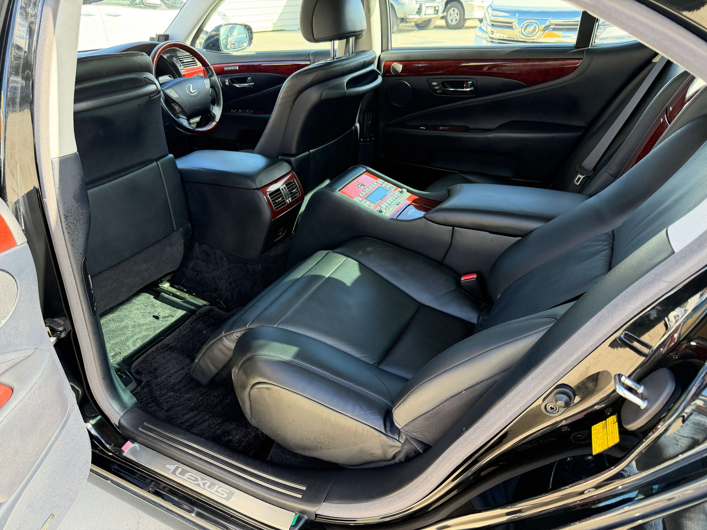 Interior view of 2007 Lexus LS600hL AWD V8 5.0L Hybrid luxury sedan showcasing rear seats and cabin features.